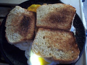 Quick before the egg white set up, slap the toast down on each egg and Spam slice, untoasted side down.