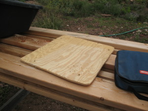 Step two: More-or-less draw an outline of the tub's bottom on some scrap siding, cut it to size, and drill bolt holes